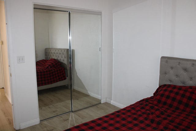 bedroom featuring light hardwood / wood-style floors and a closet