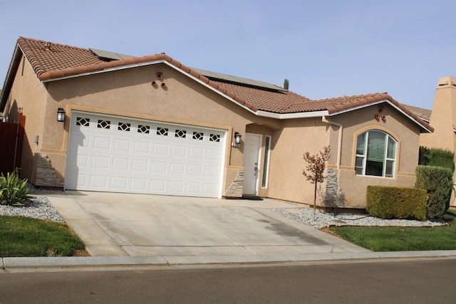 mediterranean / spanish house featuring a garage