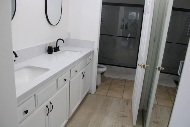 bathroom with tile patterned flooring, vanity, toilet, and an enclosed shower