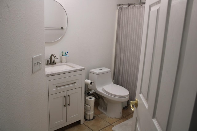 bathroom with tile patterned floors, vanity, and toilet