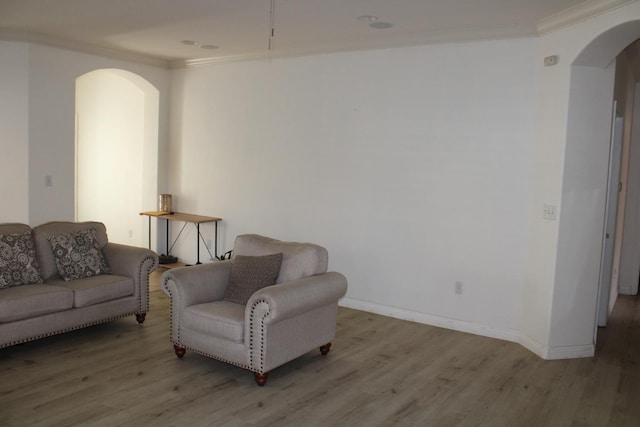 living room featuring light hardwood / wood-style flooring and ornamental molding