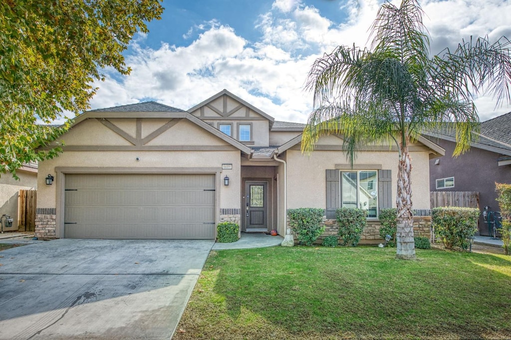 view of front of property featuring a garage and a front lawn