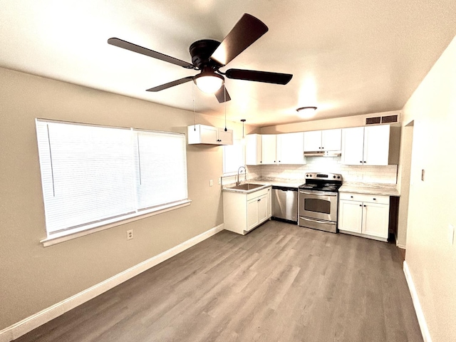 kitchen featuring sink, white cabinetry, stainless steel appliances, and light hardwood / wood-style flooring