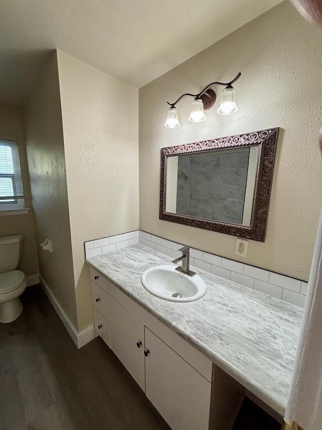 bathroom featuring hardwood / wood-style floors, vanity, and toilet