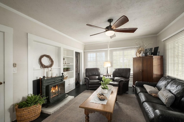 living room with a textured ceiling, ceiling fan, and ornamental molding