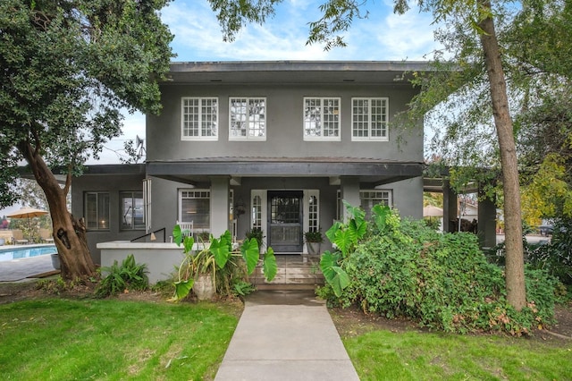 view of front of house with a front lawn and covered porch