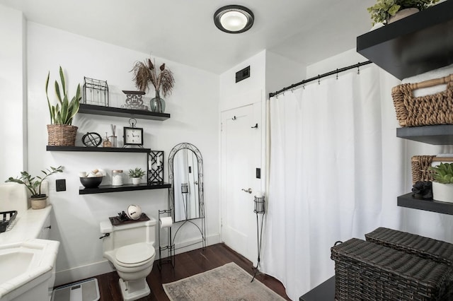 bathroom featuring hardwood / wood-style floors, vanity, and toilet