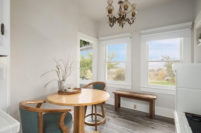 sunroom / solarium with a notable chandelier