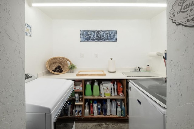 washroom with sink and washer and dryer