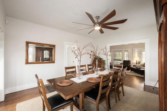 dining area featuring ceiling fan and dark hardwood / wood-style floors