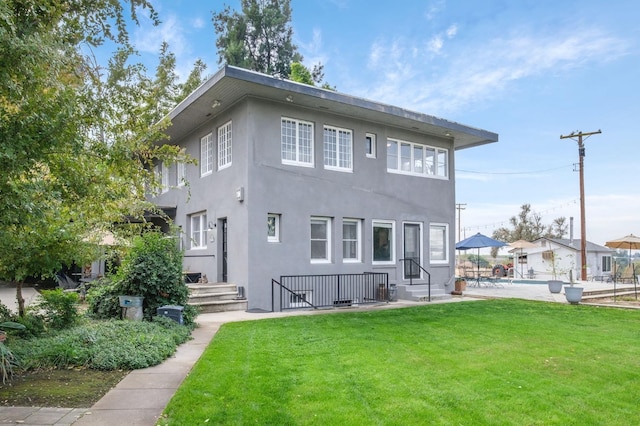 rear view of property with a lawn