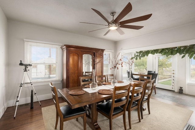 dining space featuring ceiling fan, dark hardwood / wood-style flooring, a textured ceiling, and crown molding