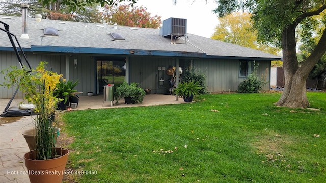 back of property featuring a yard and a patio area