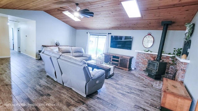 living room featuring wood ceiling, vaulted ceiling, ceiling fan, dark hardwood / wood-style floors, and a wood stove