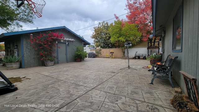 view of patio featuring an outbuilding