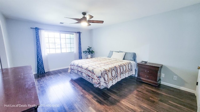 bedroom with dark hardwood / wood-style floors and ceiling fan