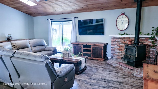 living room featuring a wood stove, hardwood / wood-style floors, and wooden ceiling