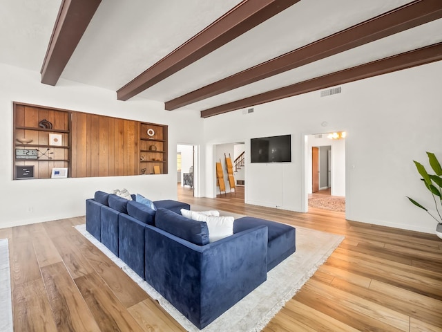 living room featuring hardwood / wood-style flooring and beam ceiling