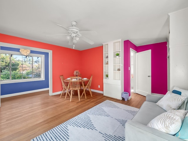 living room with ceiling fan and wood-type flooring