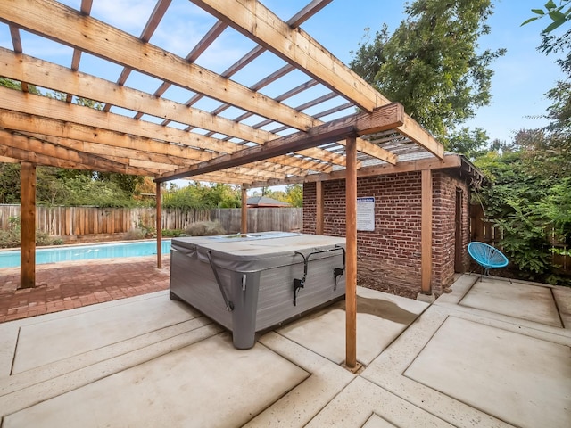 view of patio featuring a swimming pool with hot tub