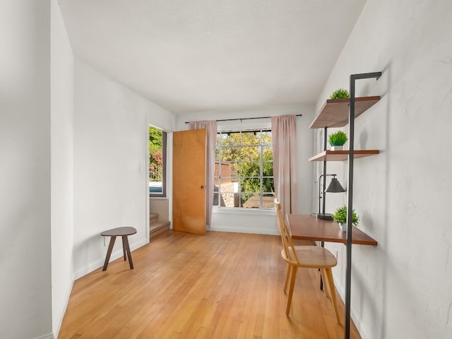 home office with light hardwood / wood-style floors