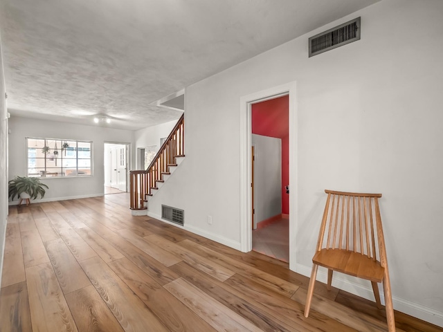 interior space with light hardwood / wood-style floors and a textured ceiling