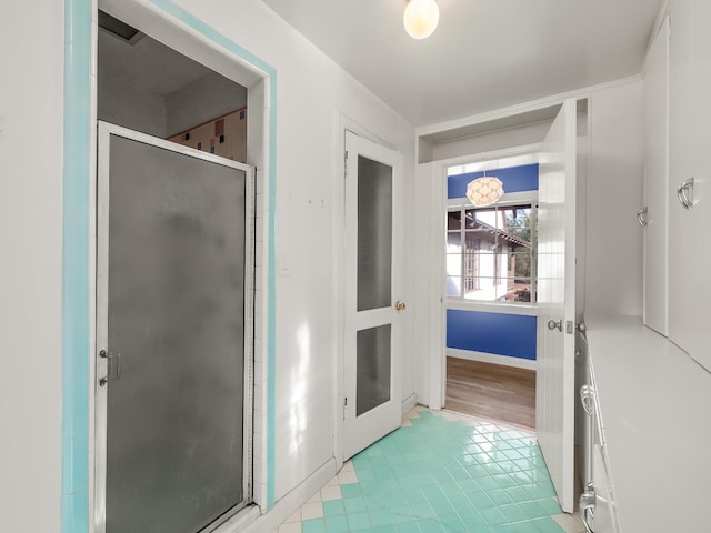 bathroom featuring tile patterned flooring and an enclosed shower