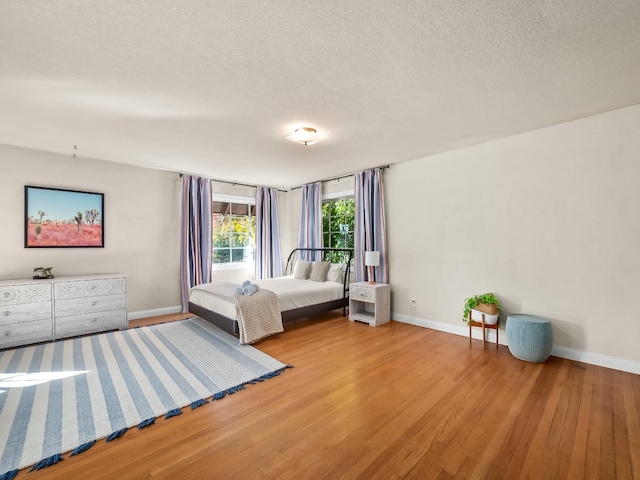 unfurnished bedroom with hardwood / wood-style floors and a textured ceiling