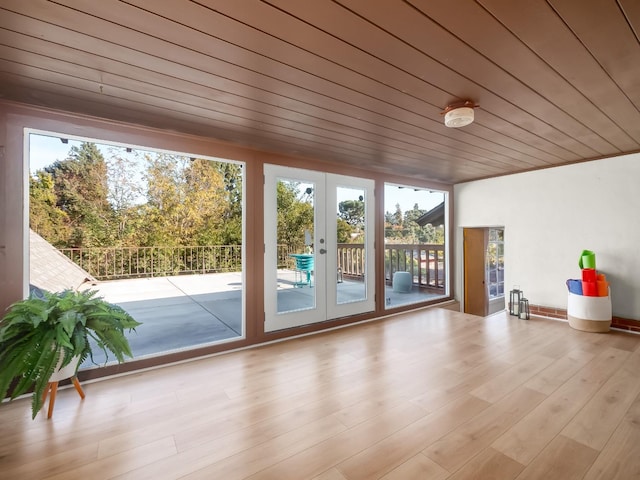 interior space featuring light hardwood / wood-style flooring, a wealth of natural light, and wood ceiling