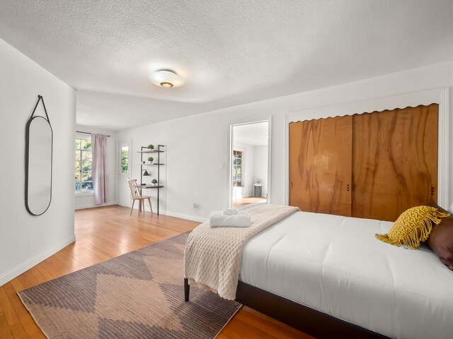 bedroom featuring wood-type flooring and a textured ceiling