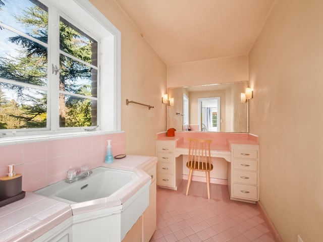 bathroom with tile patterned floors and tasteful backsplash