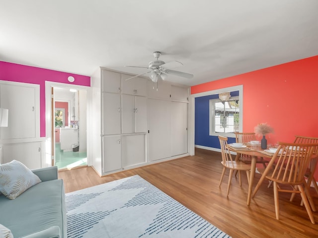 living room with ceiling fan and hardwood / wood-style floors