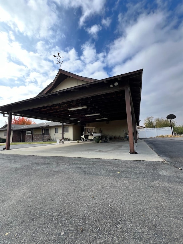 view of parking / parking lot featuring a carport