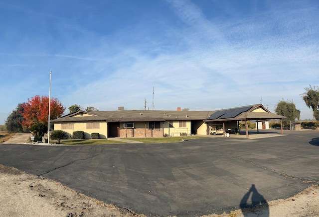 ranch-style house featuring a carport