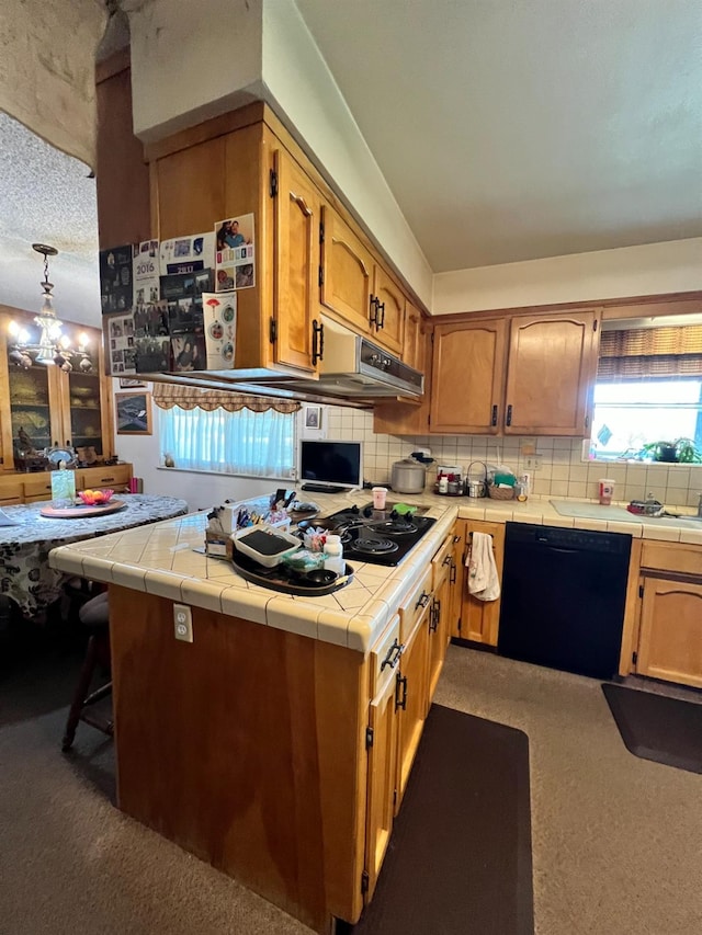 kitchen with pendant lighting, dark carpet, tile counters, and black appliances