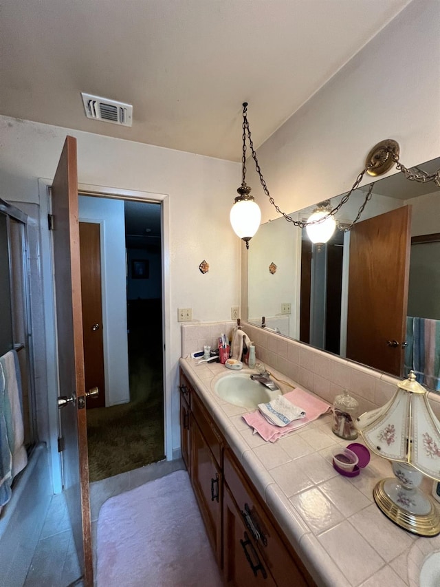 bathroom featuring tile patterned flooring and vanity