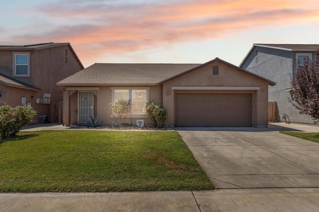 view of front of house with a lawn and a garage