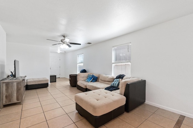 tiled living room featuring ceiling fan