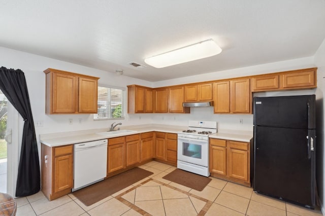 kitchen featuring sink, light tile patterned floors, and white appliances