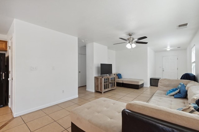 tiled living room with ceiling fan