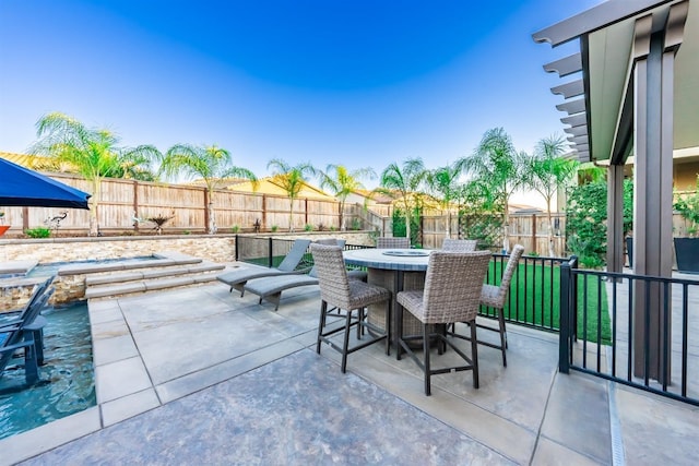 view of patio with a fenced backyard and outdoor dining area