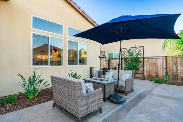 view of patio featuring fence and an outdoor living space