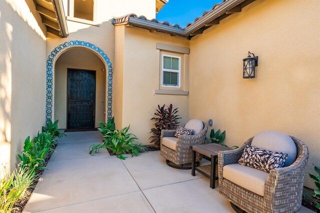 property entrance with a patio and stucco siding