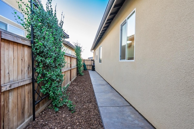 view of home's exterior featuring fence and stucco siding