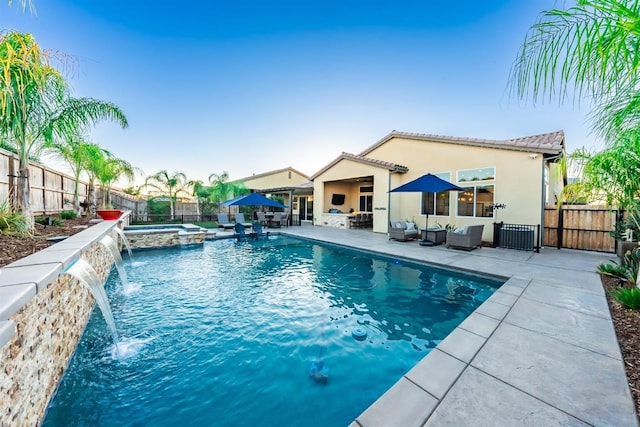 view of swimming pool featuring a patio, a pool with connected hot tub, a fenced backyard, and an outdoor living space