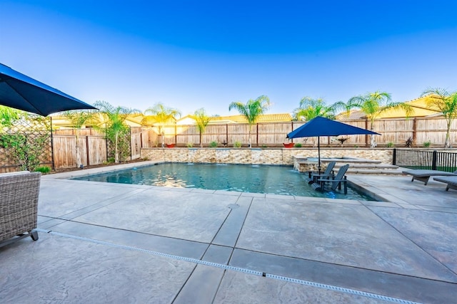 view of swimming pool featuring a patio area, a fenced backyard, and a fenced in pool