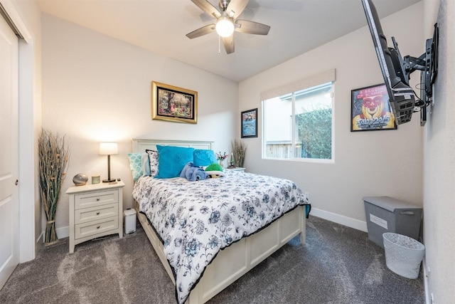 bedroom featuring ceiling fan, a closet, dark carpet, and baseboards