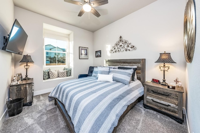 carpeted bedroom featuring ceiling fan, a fireplace, and baseboards