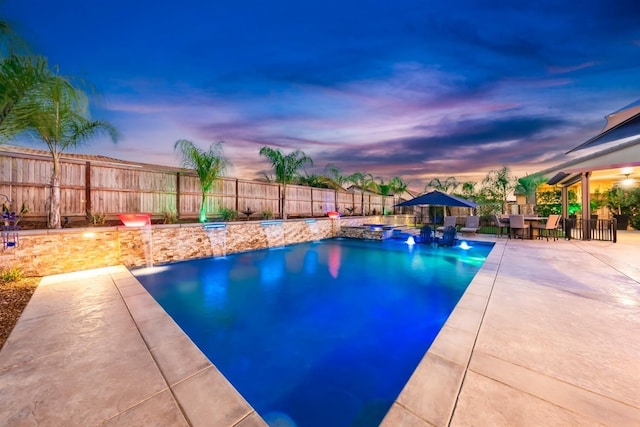 view of swimming pool featuring a fenced in pool, outdoor dining space, a fenced backyard, and a patio