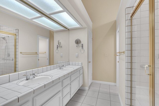 bathroom featuring tile patterned flooring, vanity, and a shower with door